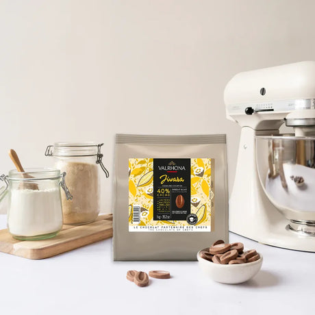 Sachet de fèves de chocolat au lait Jivara 40% de Valrhona pour la pâtisserie, format 1 kg, présenté sur fond clair.